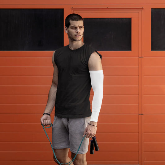 Man holding a jump rope in front of an orange wall