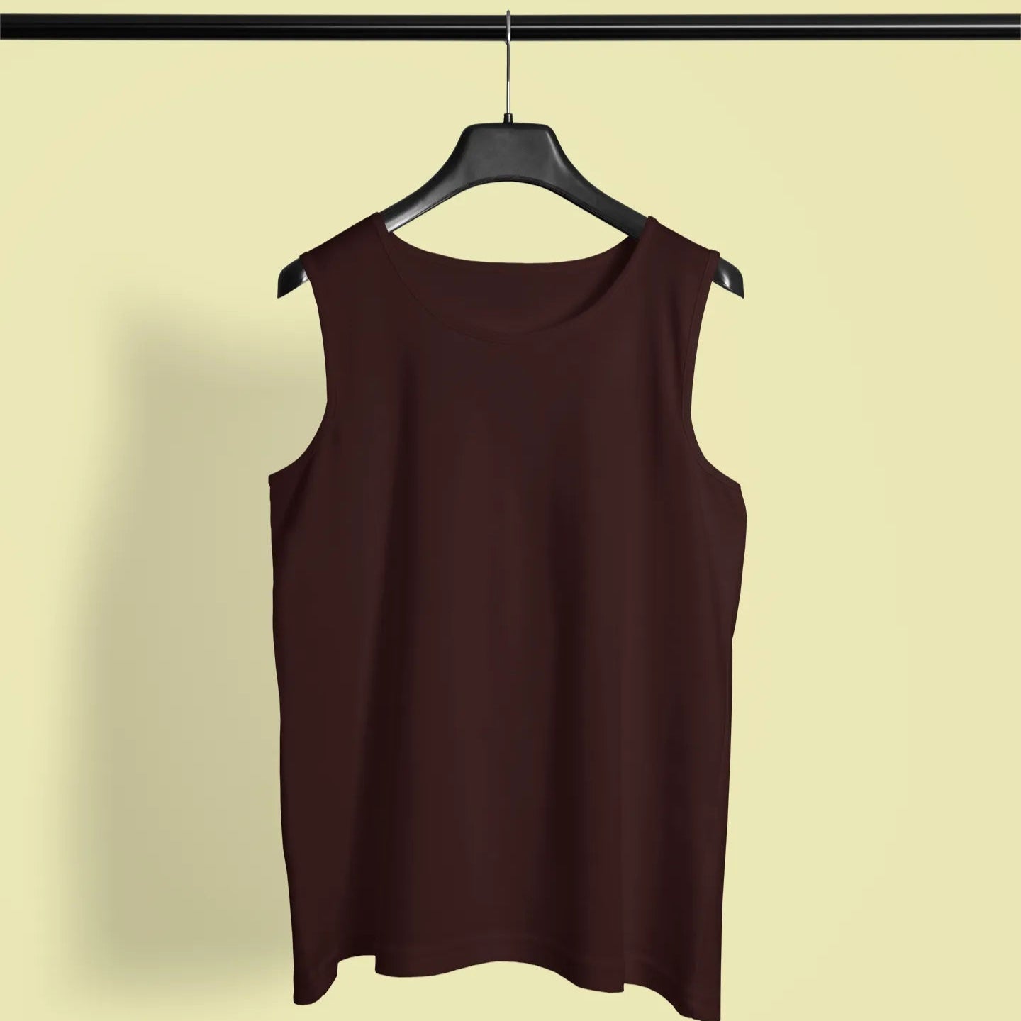Brown sleeveless top on a hanger against a beige background