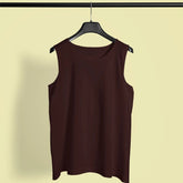 Brown sleeveless top on a hanger against a beige background