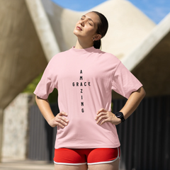 Person wearing a pink t-shirt with text and red shorts outdoors