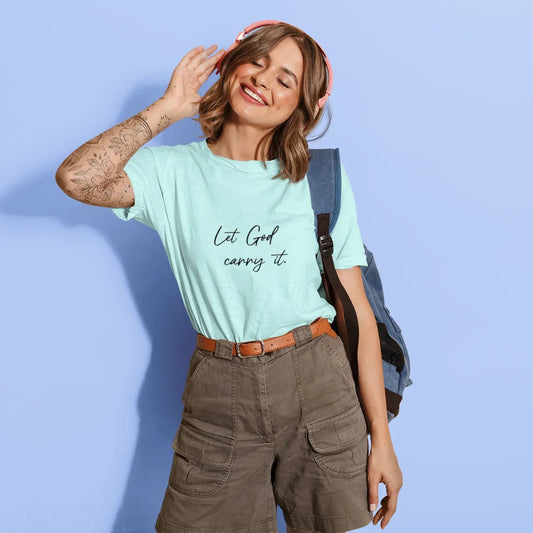 Woman wearing a light blue t-shirt with text, standing against a light blue background