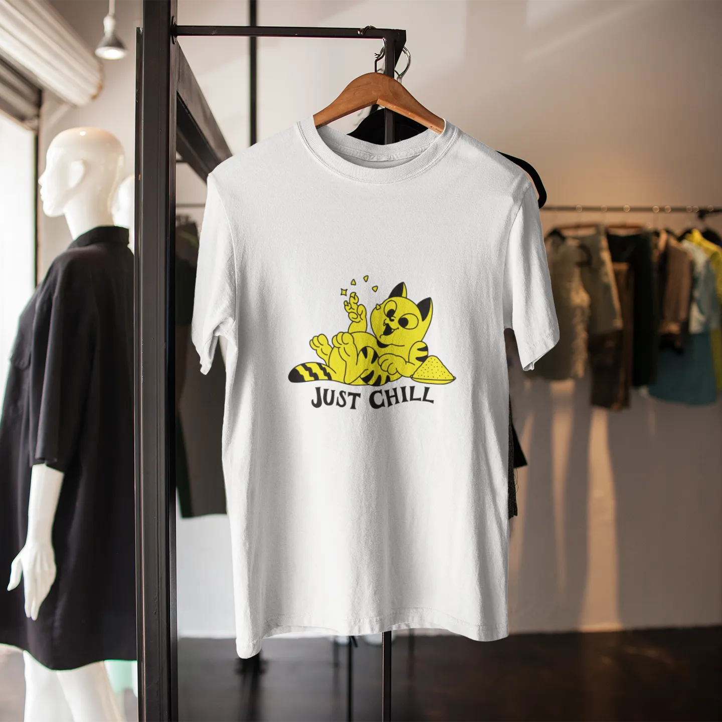 White t-shirt with a Pikachu graphic and 'Just Chill' text on a rack in a store.