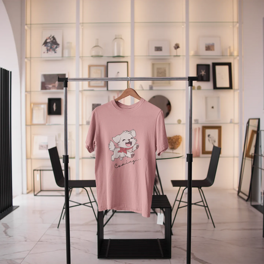 Pink sweater with a graphic design on a rack in a modern interior setting.