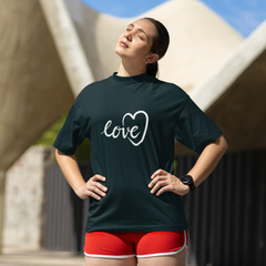Woman wearing a black t-shirt with 'love' printed on it, standing outdoors.