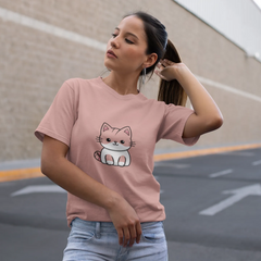 Woman wearing a pink t-shirt with a cat graphic in an outdoor setting