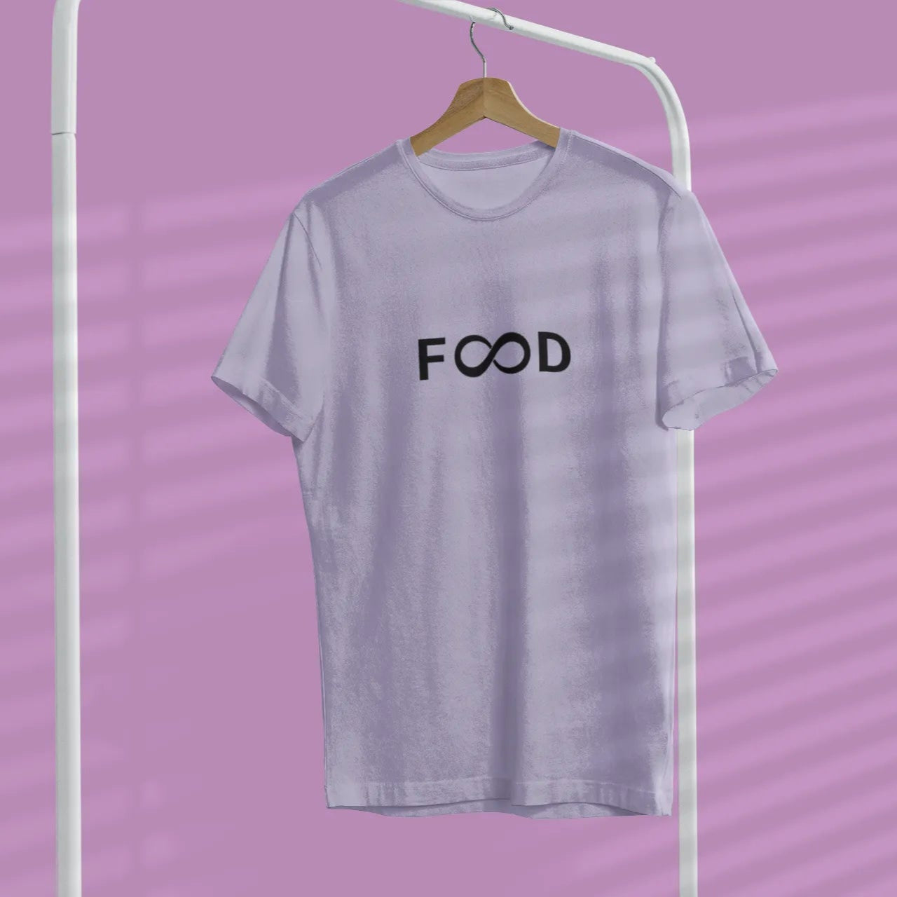 Gray t-shirt with 'FOOD' text on a hanger against a purple background
