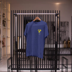 Blue t-shirt with a yellow graphic on a black metal rack.