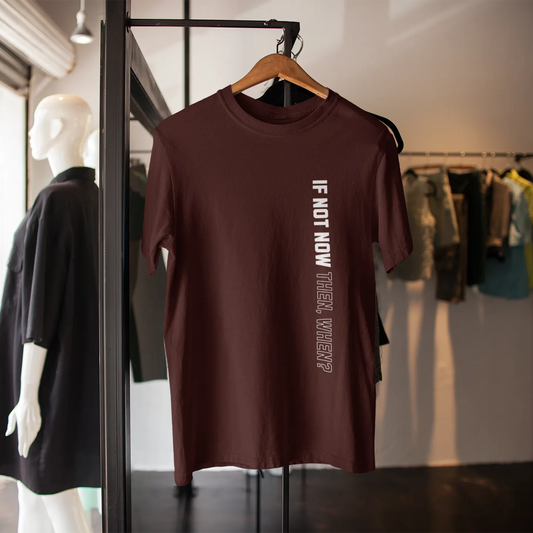 Brown t-shirt with text on a hanger in a clothing store