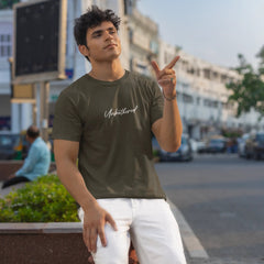 Man wearing a green t-shirt with 'Unshaven' text, standing on a street.