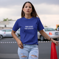 Woman wearing a blue t-shirt with text, standing in an outdoor setting with cars and a red cone.