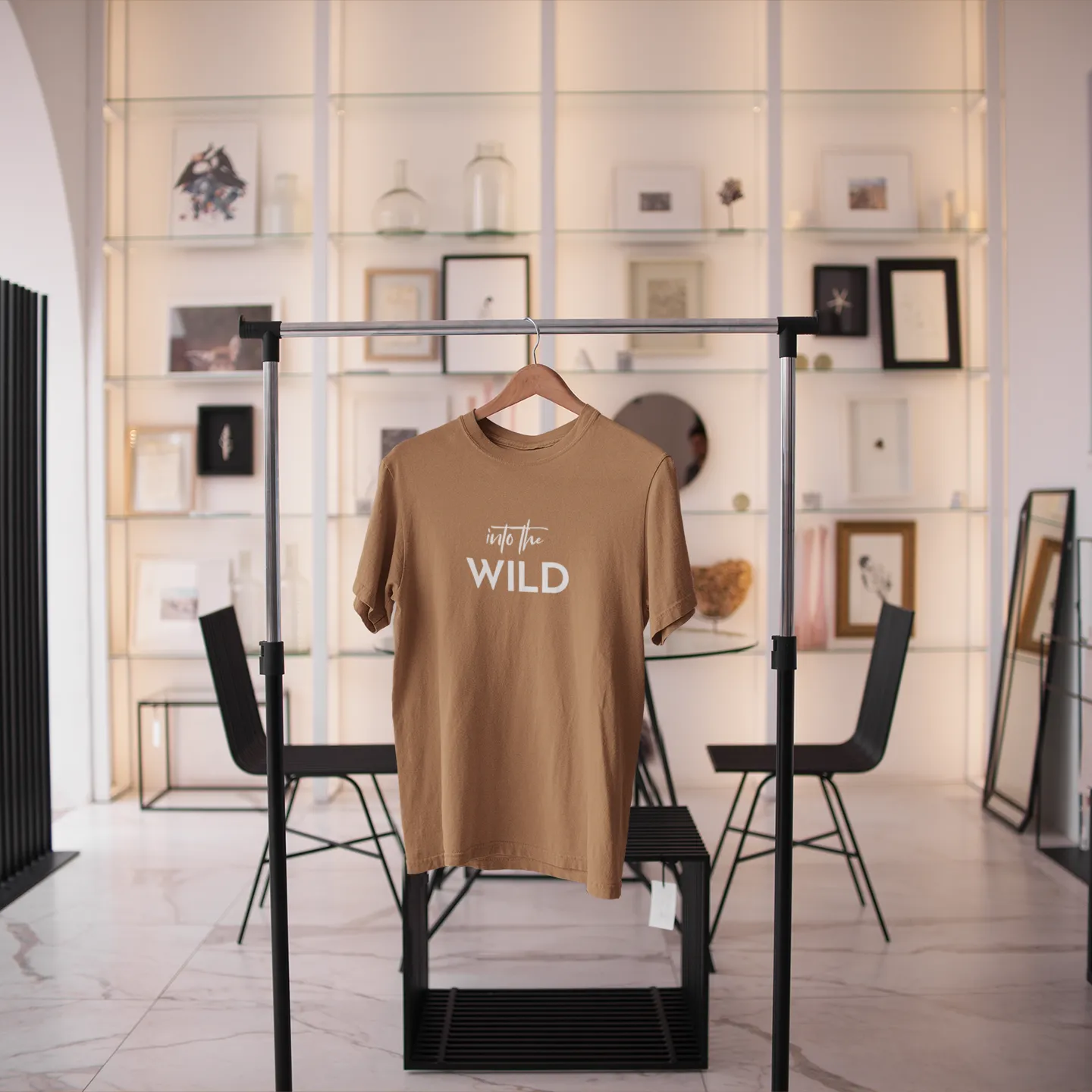 Brown t-shirt with 'Go Wild' text on a rack in a modern interior setting