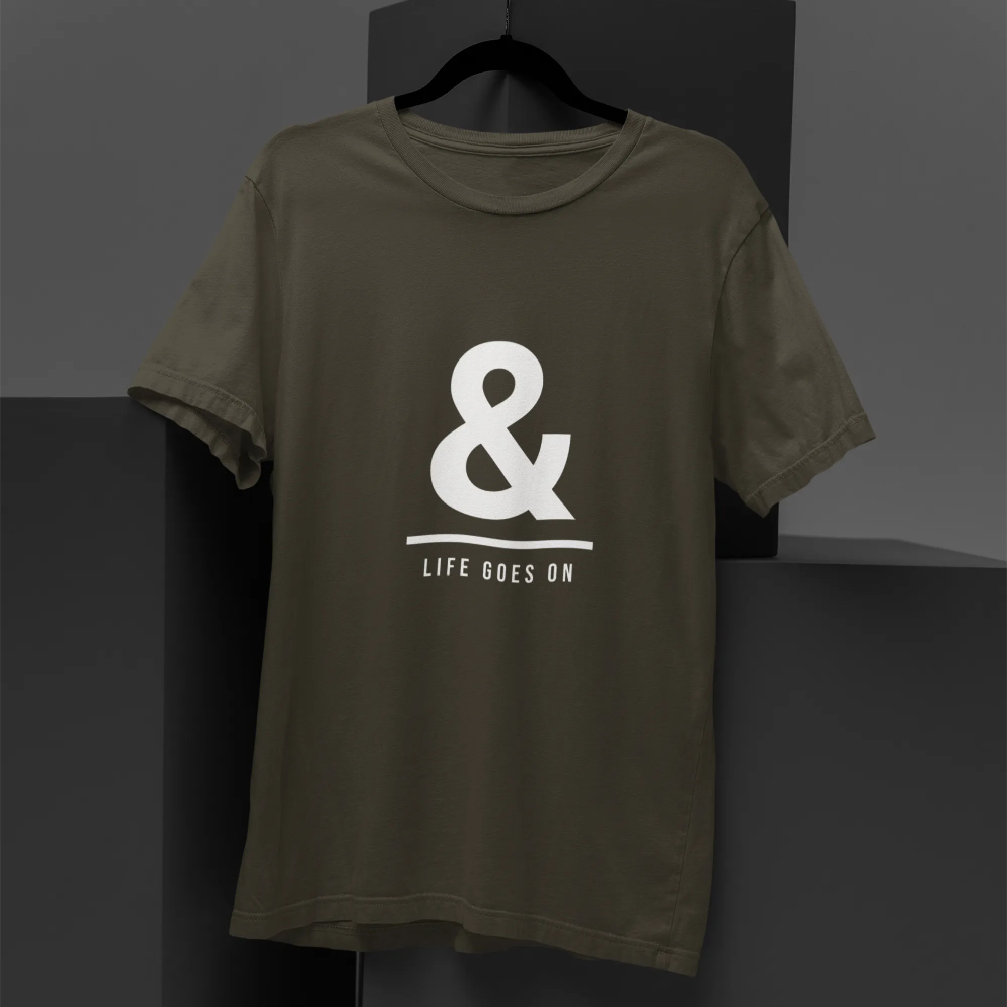 Green t-shirt with a white logo and text on a dark background