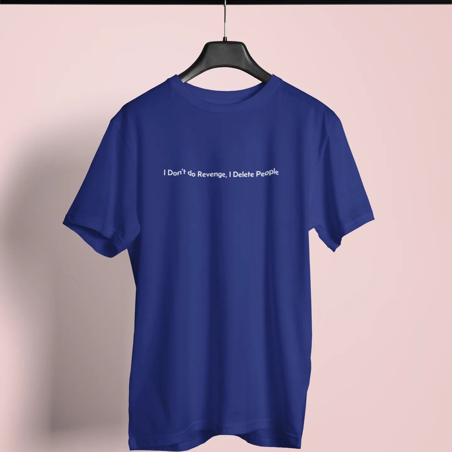 Blue t-shirt with text on a hanger against a pink background