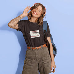 Woman wearing a black t-shirt with text, standing against a light blue background