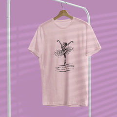 Pink t-shirt with a graphic design of a ballerina on a hanger against a purple background