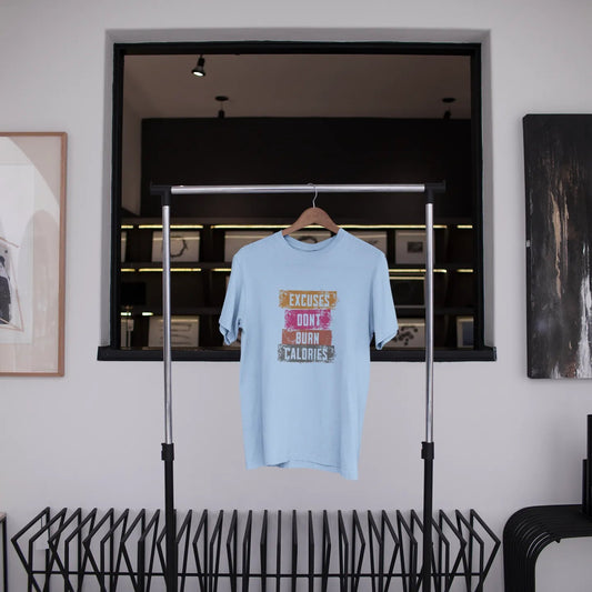 Light blue t-shirt with text on a hanger in a room with abstract art and shelves.
