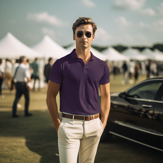Man wearing a purple polo shirt and sunglasses at an outdoor event with tents and a car in the background.