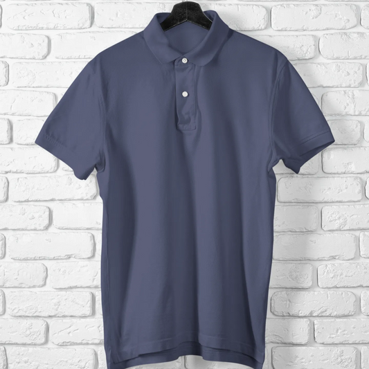 Blue polo shirt on a hanger against a white brick wall