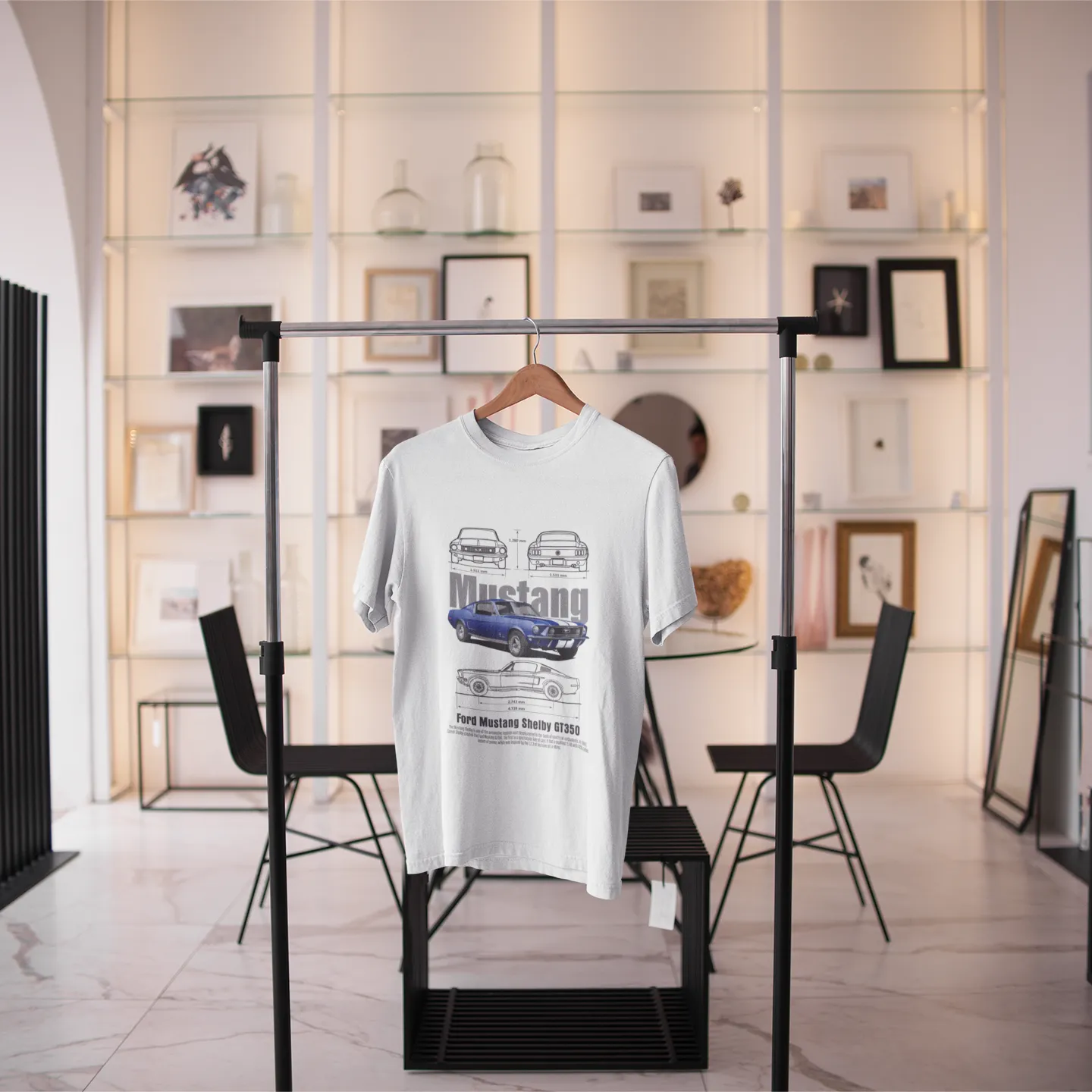 White t-shirt with graphic design on a hanger in a modern interior setting