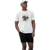 Man wearing a white t-shirt with a graphic design in an indoor setting