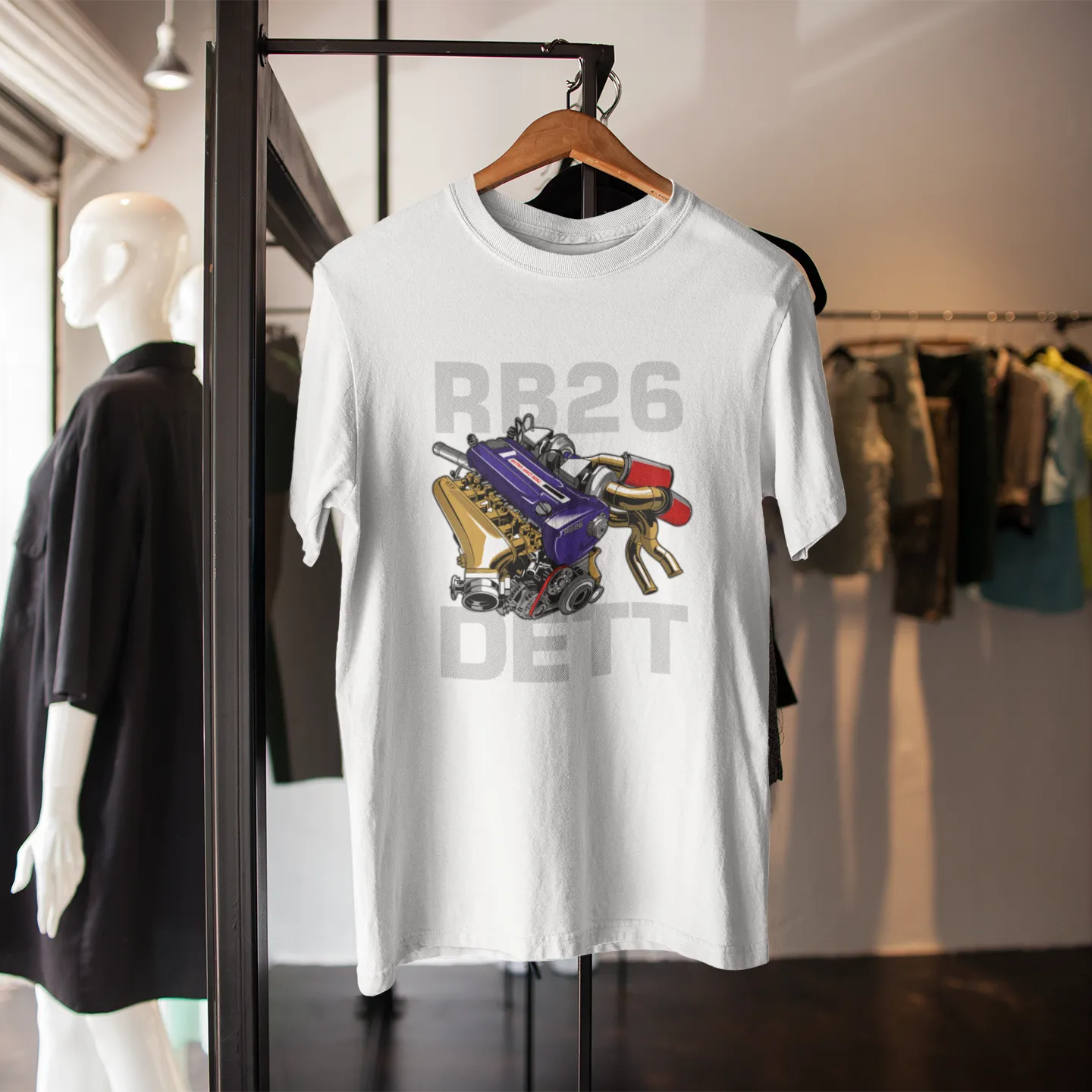 White t-shirt with engine graphic and text on a hanger in a store setting