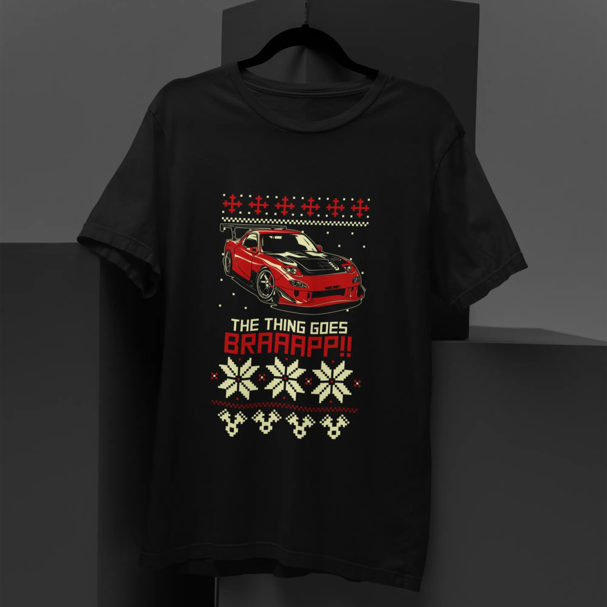Black t-shirt with a red car graphic and text on a dark background