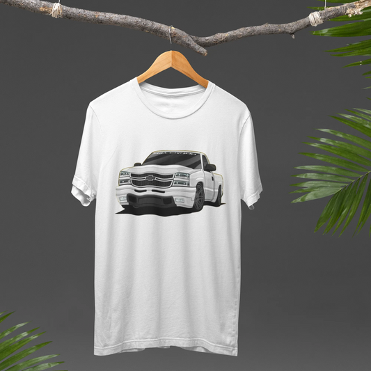 White t-shirt with a car graphic on a hanger against a dark background with green leaves.