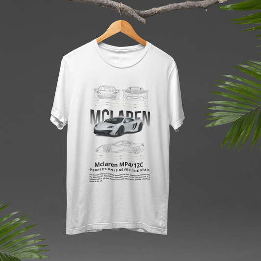 White t-shirt with McLaren logo on a hanger against a dark background with green leaves.
