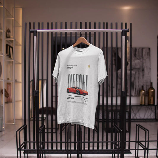 White t-shirt with red car graphic on a black metal rack in a store setting