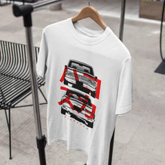 White t-shirt with graphic design on a hanger against a blurred indoor background