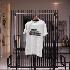 White t-shirt with a graphic design on a black metal rack in a room.