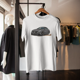 White t-shirt with a car graphic on a hanger in a store setting