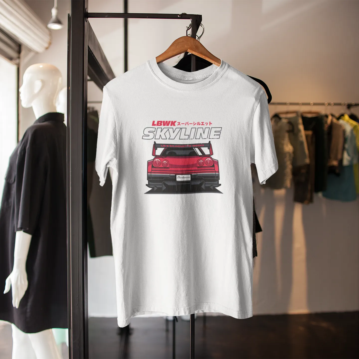White t-shirt with red car graphic and 'SKYLINE' text on a hanger in a store setting.