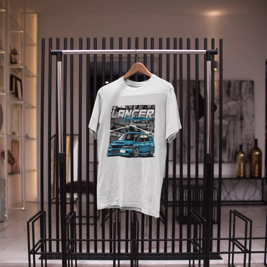White t-shirt with a graphic design on a black metal rack in a store setting.