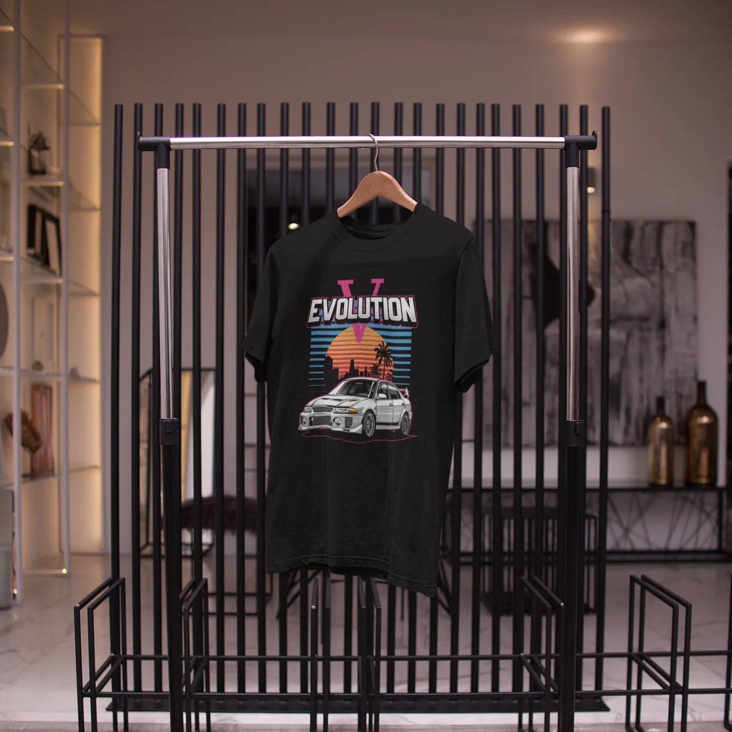 Black t-shirt with graphic design hanging on a rack in a store setting