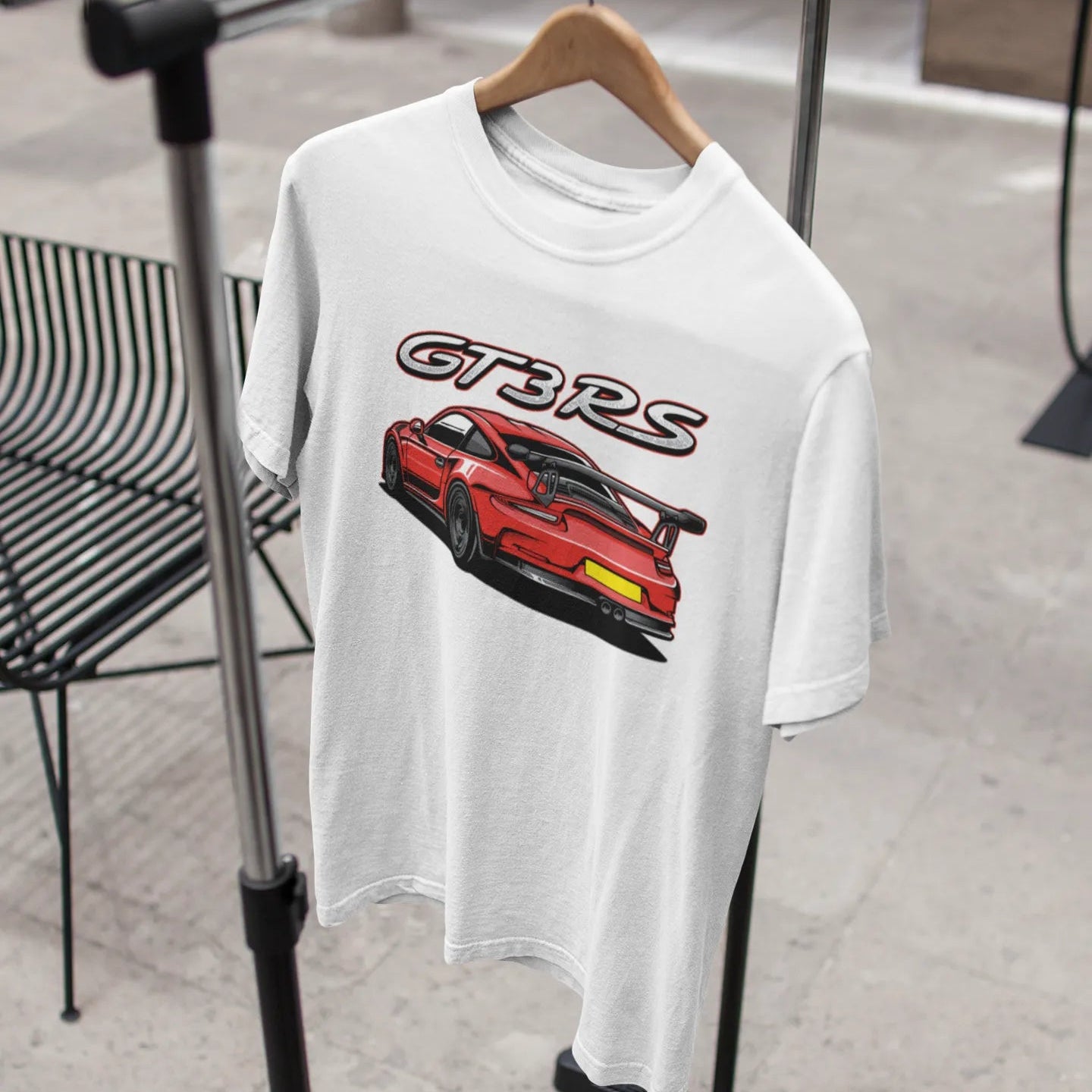 White t-shirt with red car graphic and 'GTRS' text on a hanger.