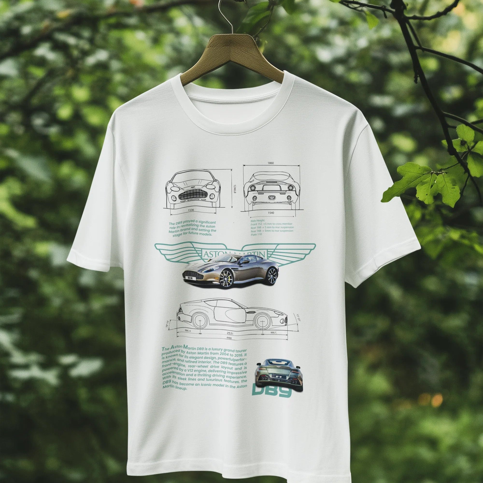 White t-shirt with car design on a hanger against a green leafy background