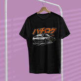 Black t-shirt with a graphic design of a car and Japanese text on a hanger against a purple background