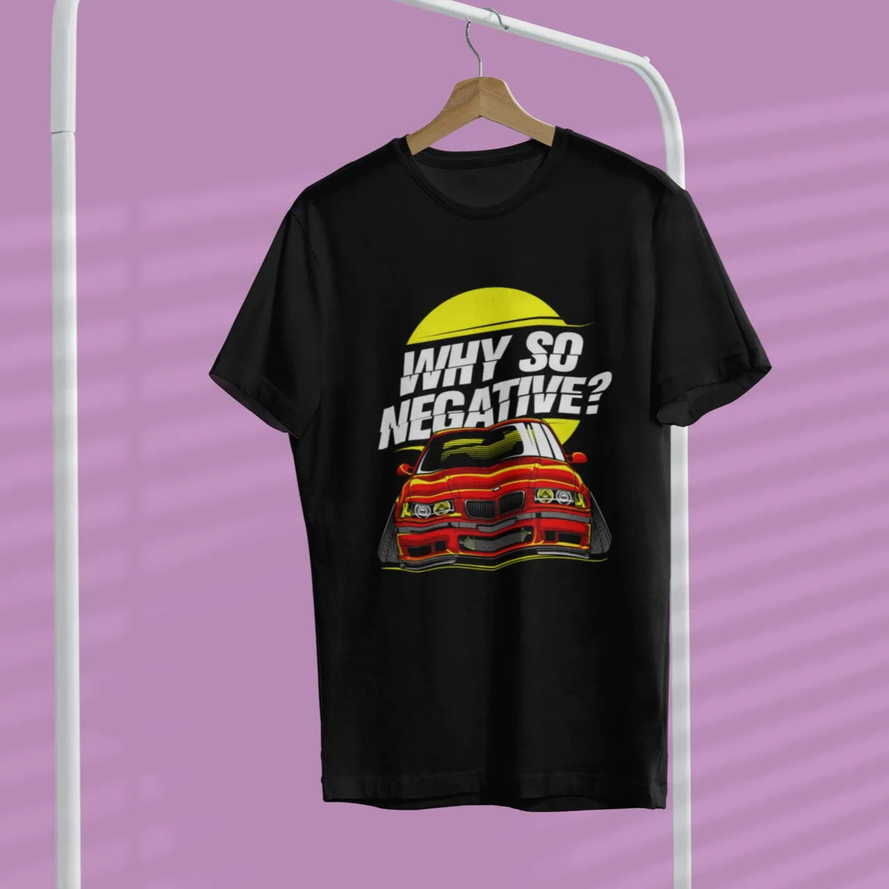 Black t-shirt with 'Why So Negative?' graphic on a hanger against a purple background