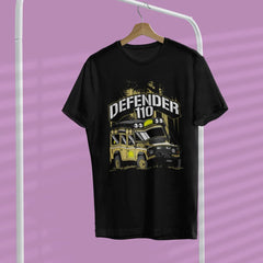Black t-shirt with a graphic design of a vehicle and 'Defender 110' text on a hanger against a purple background