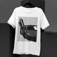 White t-shirt with a black sports car graphic on a dark background