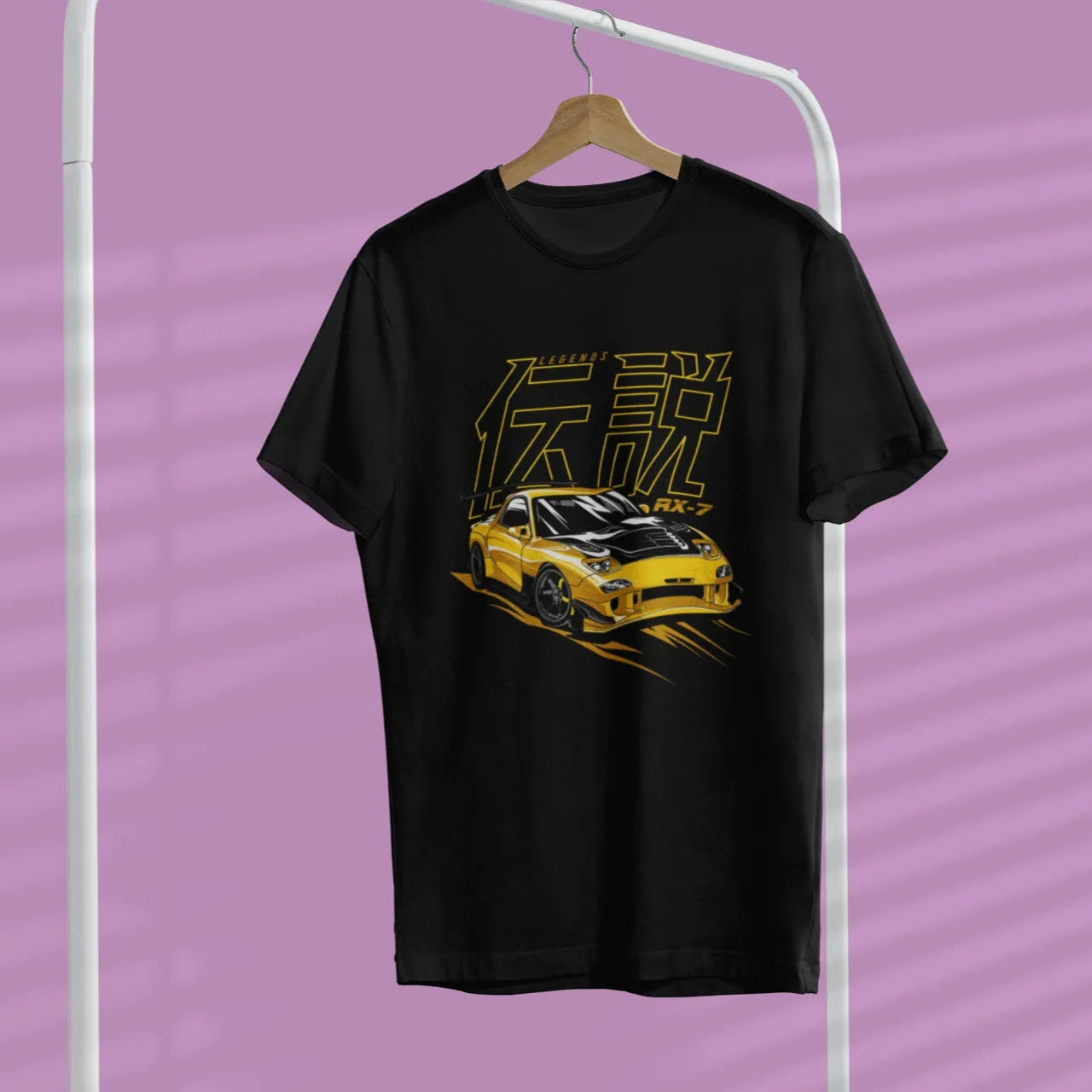 Black t-shirt with yellow graphic design on a hanger against a purple background