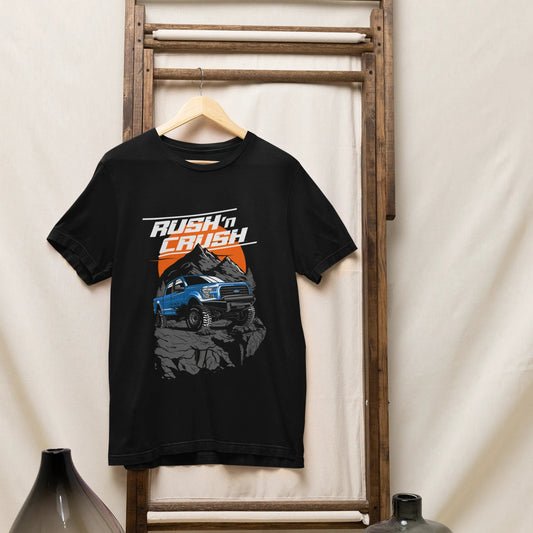 Black t-shirt with graphic design hanging on a wooden rack against a white wall.