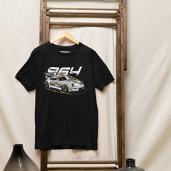 Black t-shirt with car graphic and '954' text on a wooden rack against a white wall.