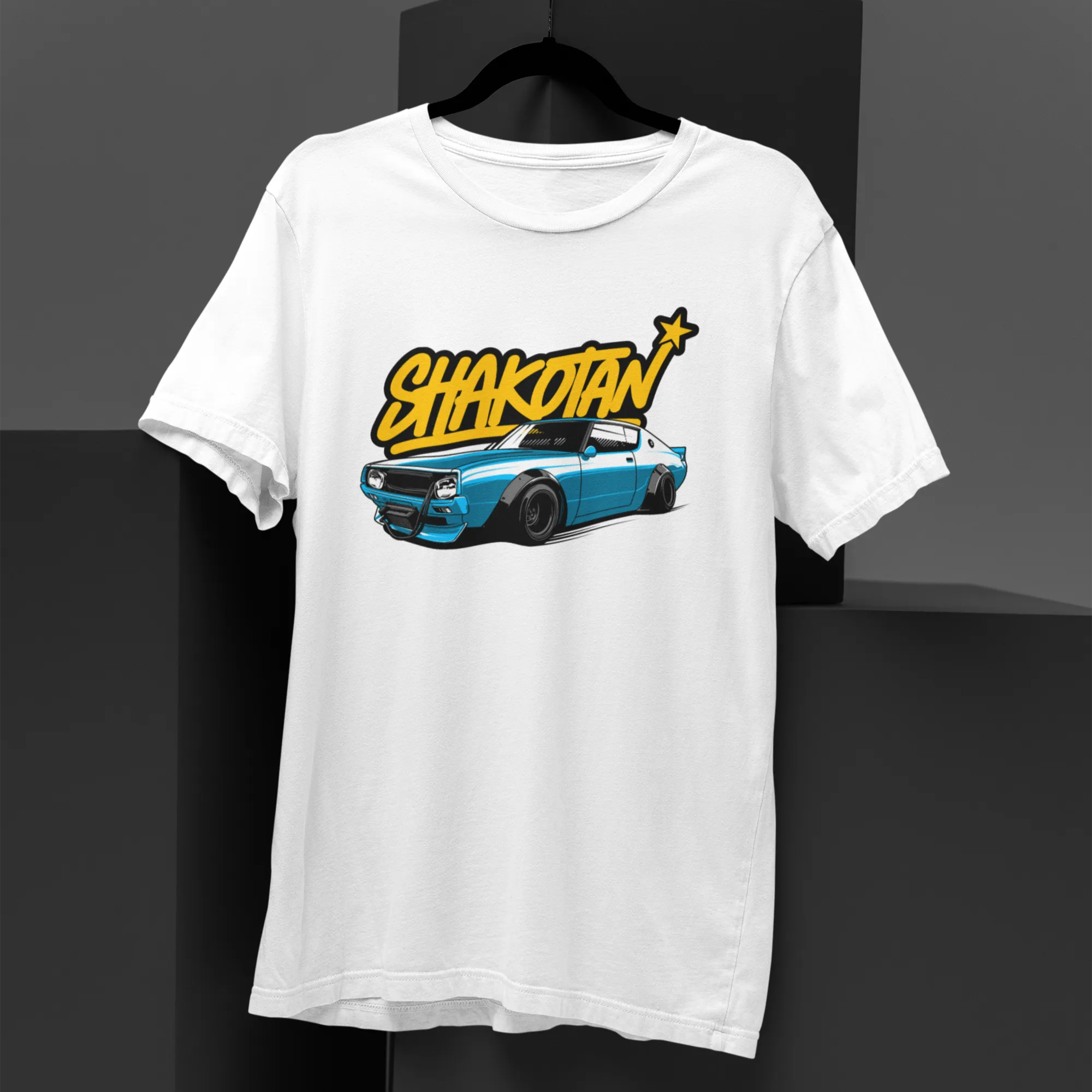 White t-shirt with a graphic design of a car and 'Shakotan' text on a black background