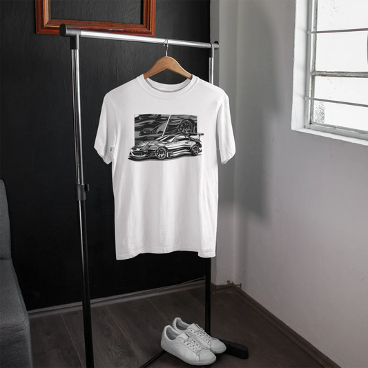 White t-shirt with a graphic design on a hanger in a room with a window.