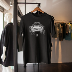 Black t-shirt with car graphic on a hanger in a store setting