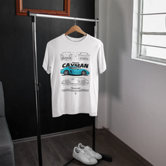 White t-shirt with car design on a hanger in a room with a window.
