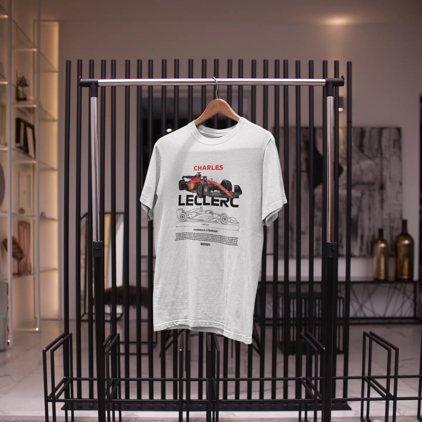 White t-shirt with Formula 1 design on a black metal rack in a store setting