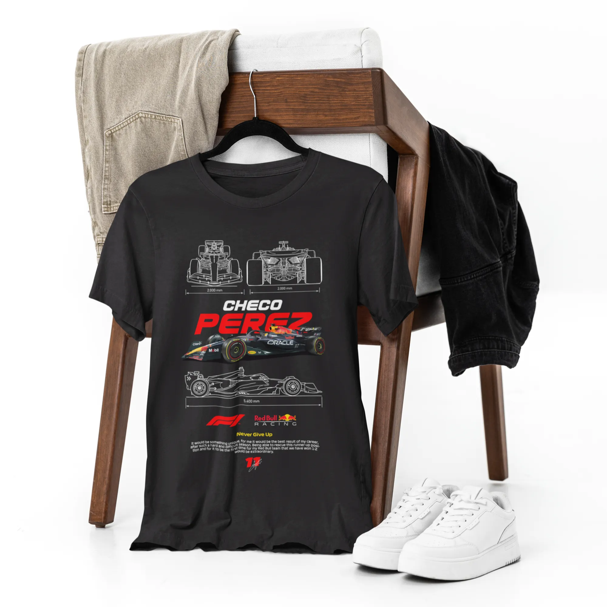 Black t-shirt with technical design on a chair with jeans and sneakers.